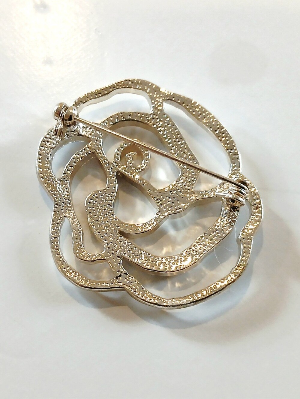 Elegant Floral Silvertone Brooch with Blue Crystal Accents - Picture 4 of 4